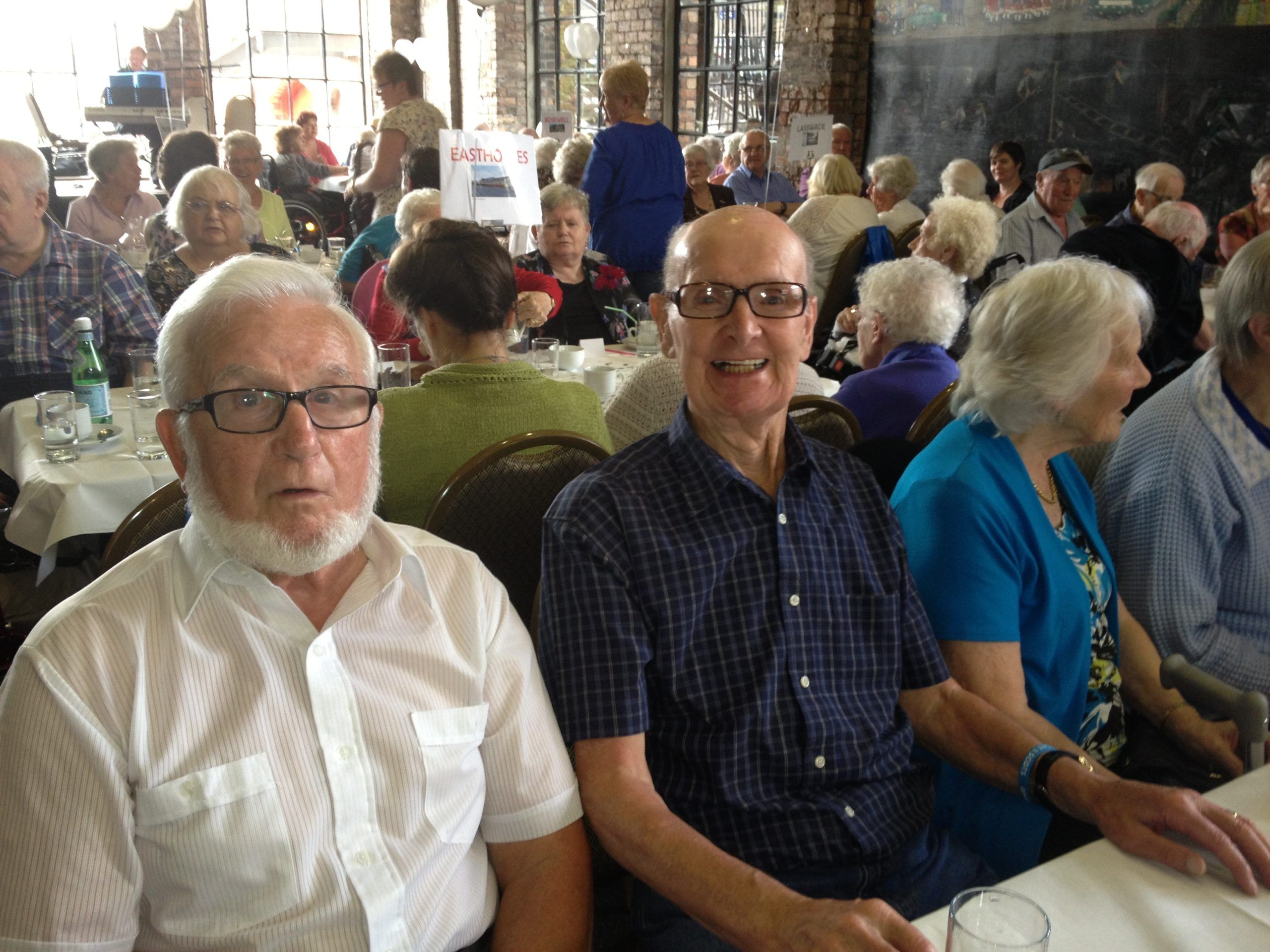A picture of elderly men celebrating the 25th Anniversary Party of St David's Bradbury Day Centre in Midlothian, a social place for the elderly