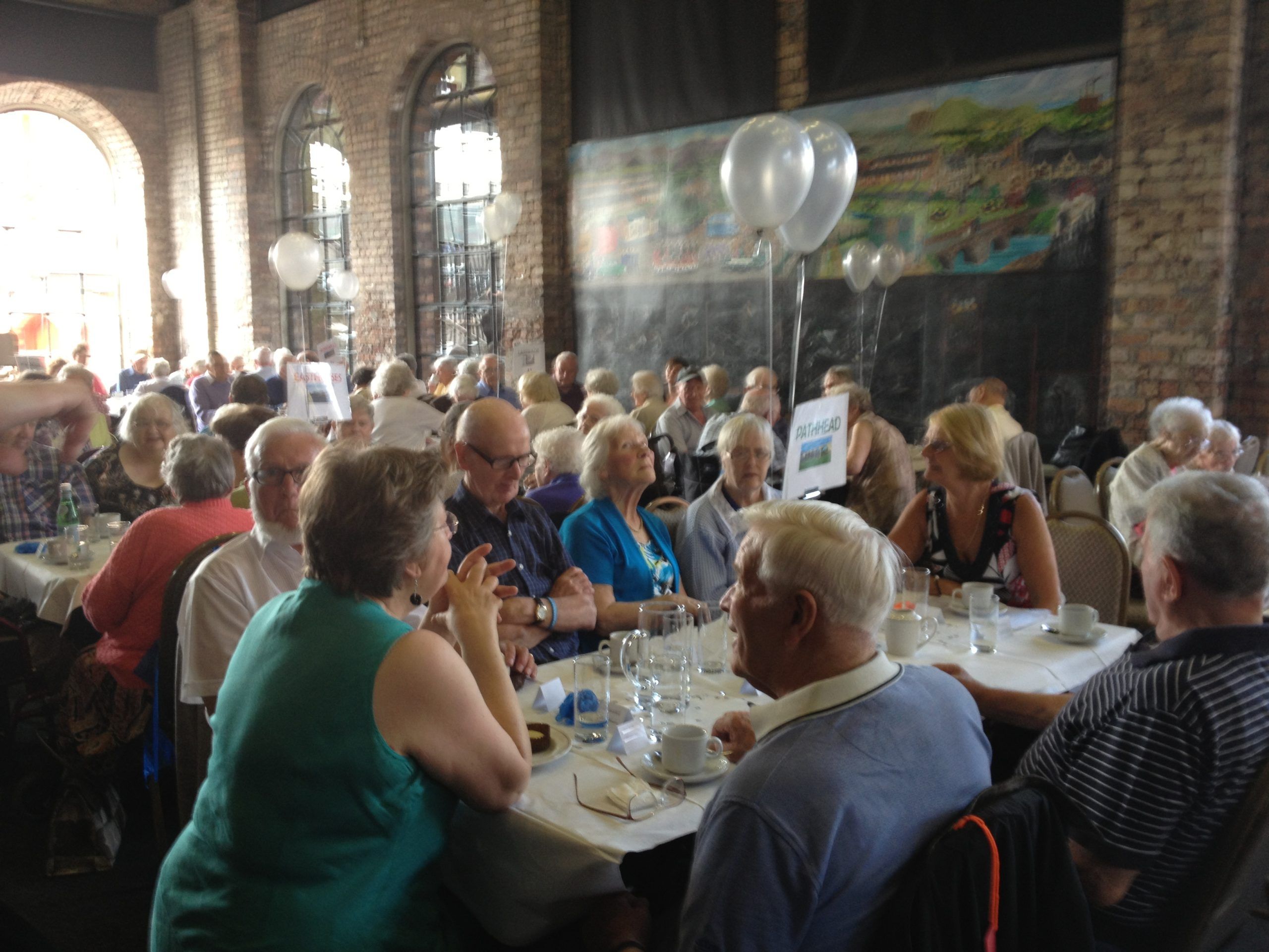 A picture of elderly having a meal celebrating the 25th Anniversary Party of St David's Bradbury Day Centre in Midlothian, a social place for the elderly