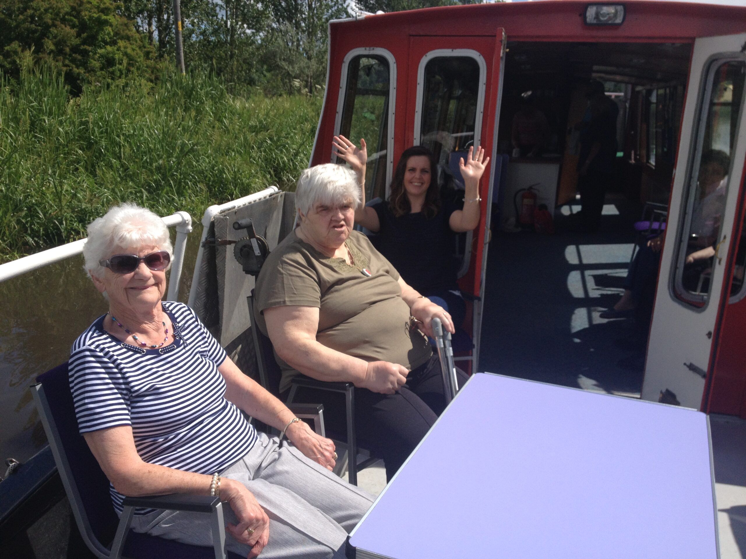 Two elderly pensioners from St David's Bradbury Day Centre in Edinburgh sitting on a canal barge