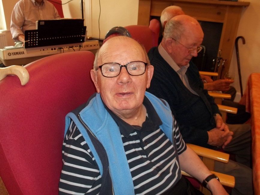 A pensioner from St David's Bradbury Day Centre in Edinburgh with a stripy jumper looking at the camera